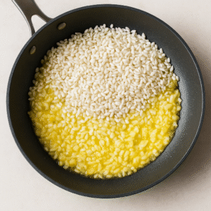 “Arborio rice and chopped onion sautéed in butter for Risotto alla Milanese”