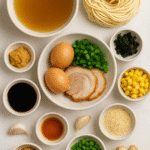 Ingredients for authentic Japanese ramen recipe – noodles, broth, pork, egg, miso, soy sauce, corn, nori, sesame seeds