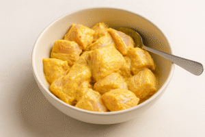 Butter Chicken step 1 – chicken pieces marinated in yogurt, garlic, ginger, and spices