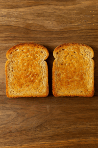 Golden toasted bread slices for making avocado egg toast.