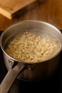 Boiling noodles in a pot of water for garlic butter shrimp ramen. 🍜