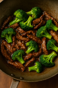 Tossing beef and broccoli together in a glossy stir-fry sauce for beef and broccoli stir fry. 🥢