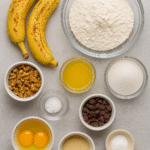 Banana Bread ingredients – ripe bananas, flour, sugar, eggs, melted butter, baking soda, salt, with optional walnuts and chocolate chips.