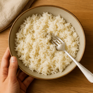 Fluffing day-old jasmine rice with a fork to prepare for thai basil fried rice. 🍚