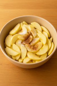 Sliced apples in a bowl being prepared for homemade apple crumble.