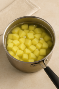 Garlic butter mashed potatoes preparation – peeled and cubed potatoes ready for cooking