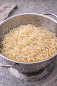 Cooked ramen noodles drained and ready for miso chicken ramen.