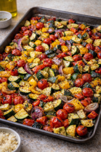Roasted Mediterranean vegetables caramelized on a baking sheet after roasting in the oven