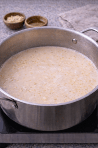 Creamy sesame chicken ramen broth after adding heavy cream and simmering.