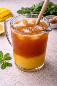 Brewed tea added to mango puree in a pitcher and stirred to combine