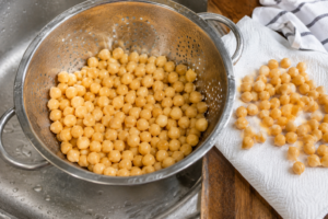 Chickpeas drained, rinsed, and dried in a colander for Mediterranean chickpea salad